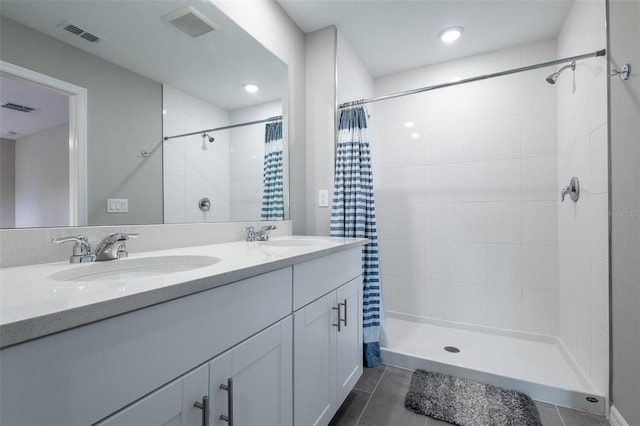 17136 Blowfish Dr, Nokomis, FL 34275 - full bath featuring a tile shower, tile patterned flooring, double vanity, and recessed lighting