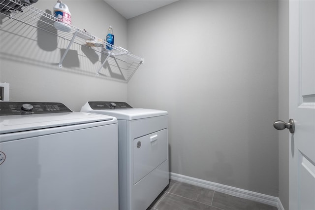 17136 Blowfish Dr, Nokomis, FL 34275 - washroom with washer and dryer and dark tile patterned flooring