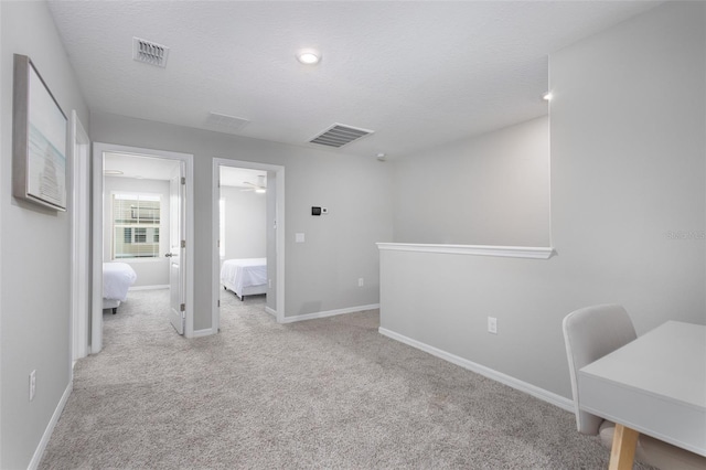 17136 Blowfish Dr, Nokomis, FL 34275 - hallway featuring carpet floors and a textured ceiling