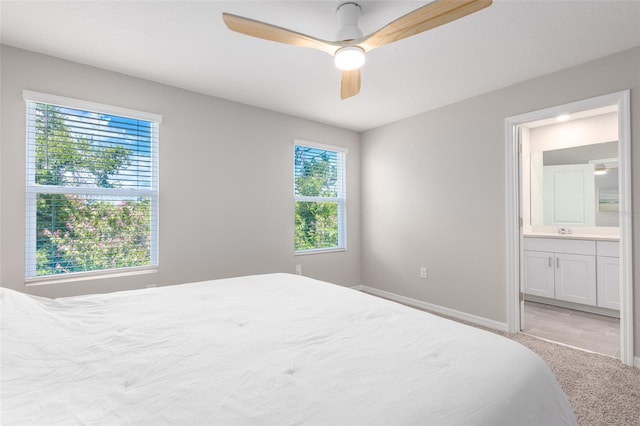 17136 Blowfish Dr, Nokomis, FL 34275 - bedroom with multiple windows, light colored carpet, ensuite bathroom, and ceiling fan