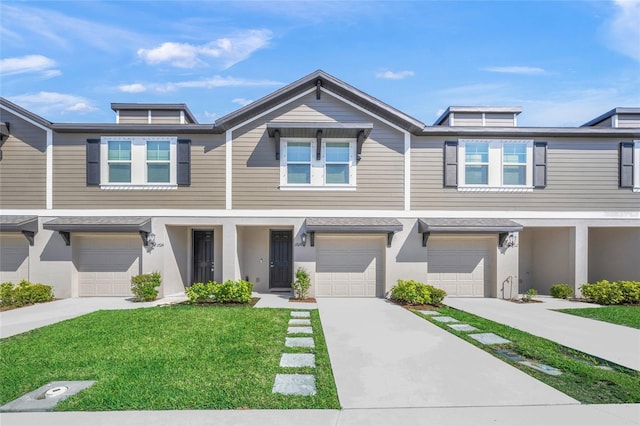 view of property featuring driveway, an attached garage, and a front yard