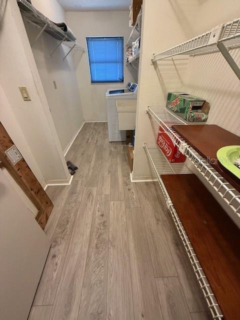 interior space with light wood-style floors and independent washer and dryer