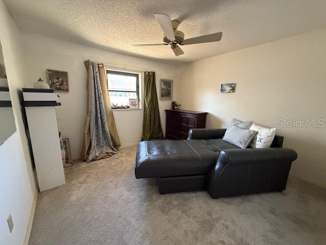 bedroom with light carpet, ceiling fan, and a textured ceiling