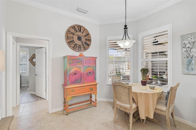 dining room with crown molding, a healthy amount of sunlight, and light tile patterned flooring