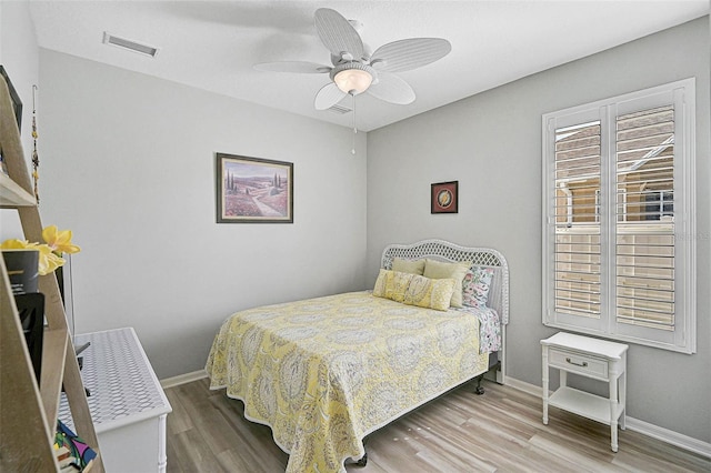 bedroom with ceiling fan and light wood-type flooring