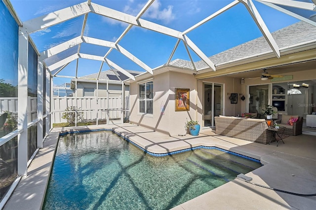 view of pool with a lanai, an outdoor hangout area, ceiling fan, and a patio area