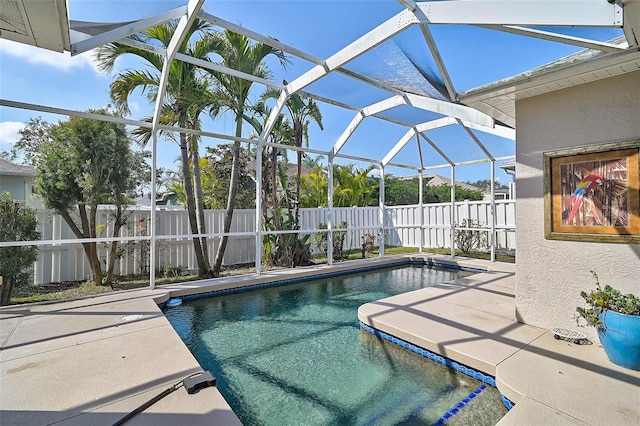 view of pool featuring a patio area and glass enclosure