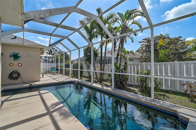 view of swimming pool featuring a lanai and a patio