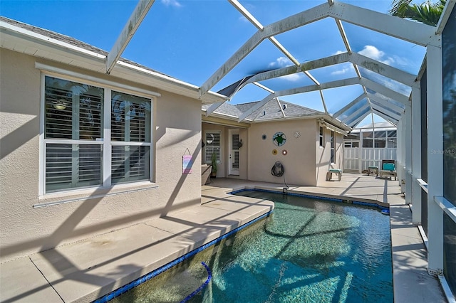 view of swimming pool featuring a lanai and a patio area