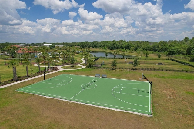 view of sport court with community basketball court, a lawn, and a water view