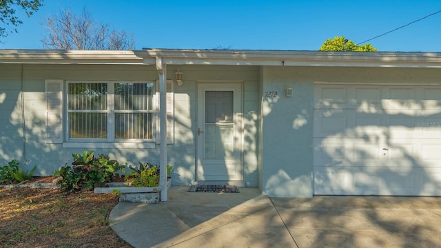 view of exterior entry featuring a garage