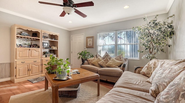 living room with ceiling fan, ornamental molding, radiator, and light parquet flooring