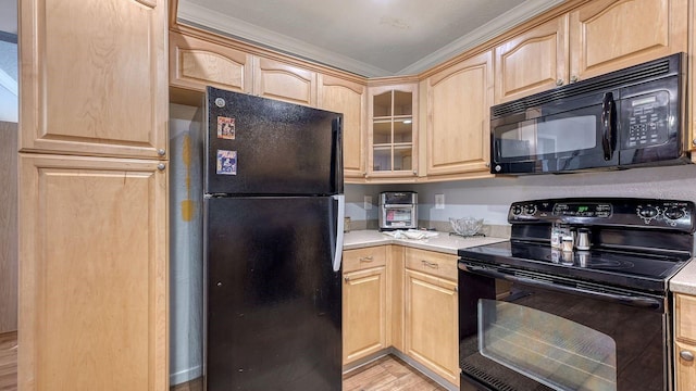 kitchen featuring light brown cabinets, light hardwood / wood-style floors, and black appliances