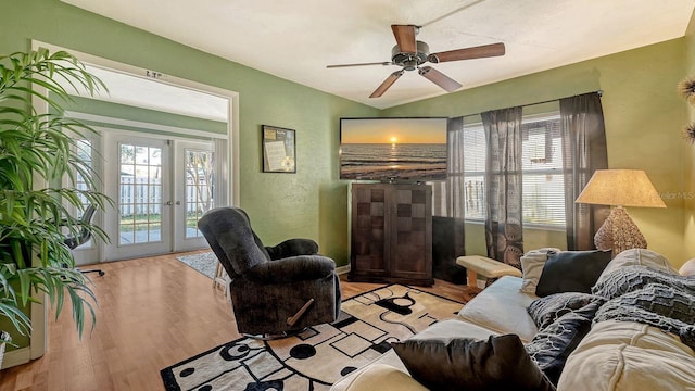 living room with french doors, ceiling fan, and light hardwood / wood-style flooring