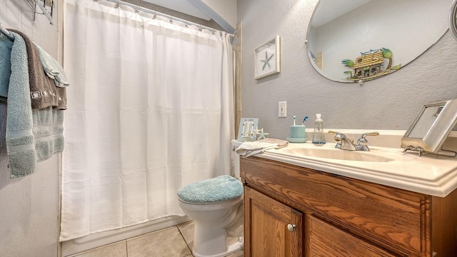 bathroom with vanity, tile patterned floors, and toilet