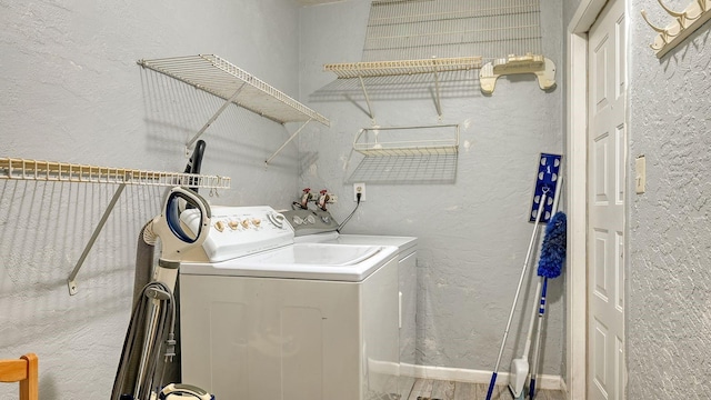 clothes washing area with washer and clothes dryer