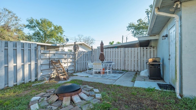 view of yard with an outdoor fire pit and a patio area