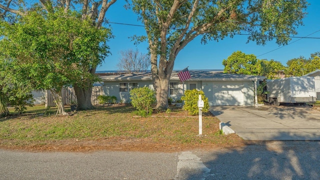 view of front of home featuring a garage and a front lawn