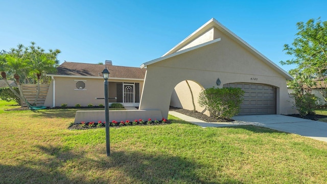 ranch-style house featuring a garage and a front lawn