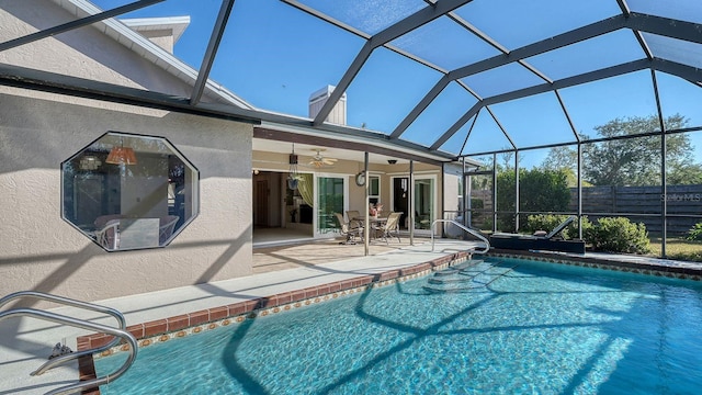 view of pool featuring a lanai, a patio, and ceiling fan