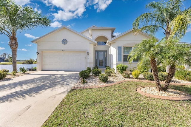 view of front of property featuring a garage, a water view, and a front yard