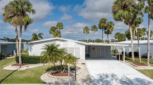 view of front facade with a front yard and a carport