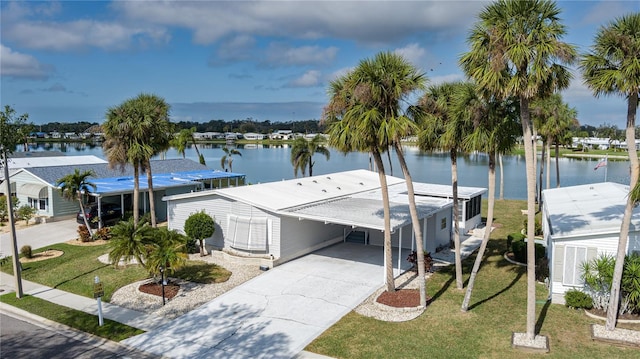 dock area with a water view and a yard