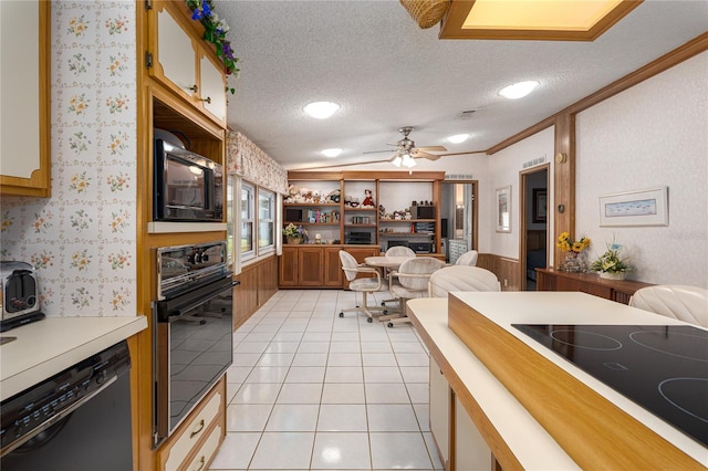 kitchen with ceiling fan, light tile patterned floors, a textured ceiling, and black appliances