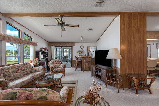 living room with vaulted ceiling with beams, light colored carpet, a textured ceiling, and ceiling fan