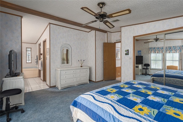 bedroom featuring ceiling fan, ornamental molding, carpet, and a textured ceiling