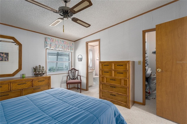 bedroom featuring ensuite bath, ornamental molding, light colored carpet, ceiling fan, and a textured ceiling