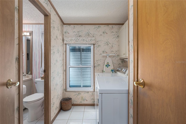 bathroom with toilet, a textured ceiling, ornamental molding, independent washer and dryer, and tile patterned flooring