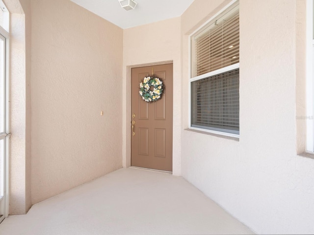 view of exterior entry featuring stucco siding