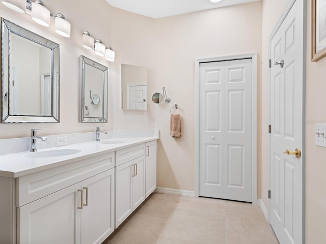 full bathroom featuring double vanity, a closet, and a sink