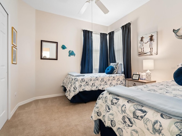 bedroom featuring carpet, baseboards, and a ceiling fan