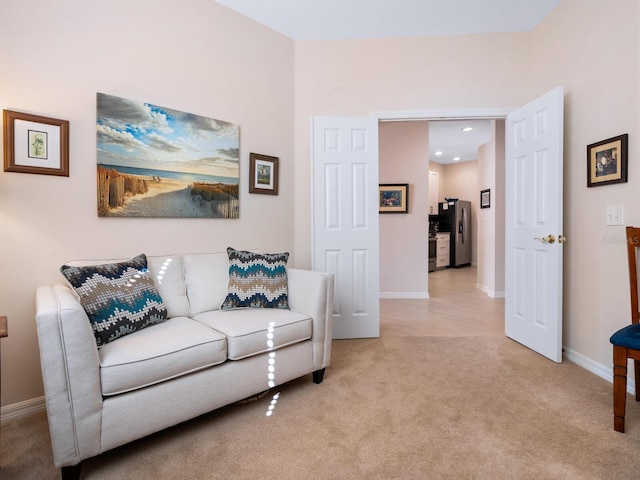 living room with light carpet and baseboards