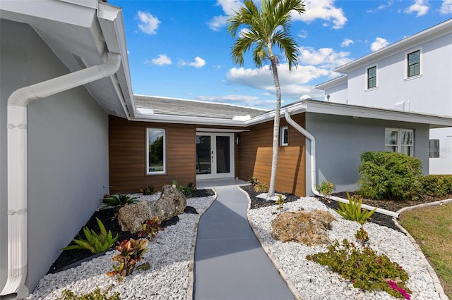 view of exterior entry featuring french doors