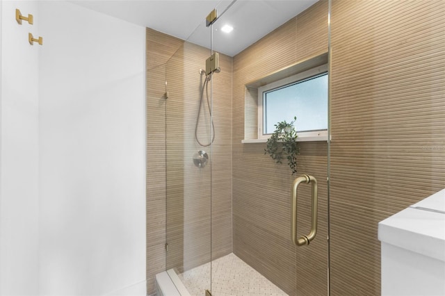 bathroom with a shower with door