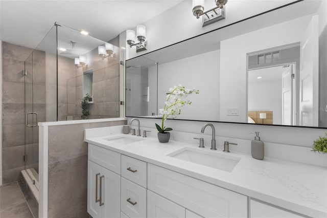 bathroom featuring vanity and an enclosed shower