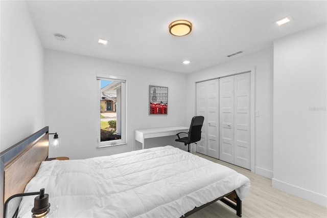 bedroom featuring a closet and light wood-type flooring