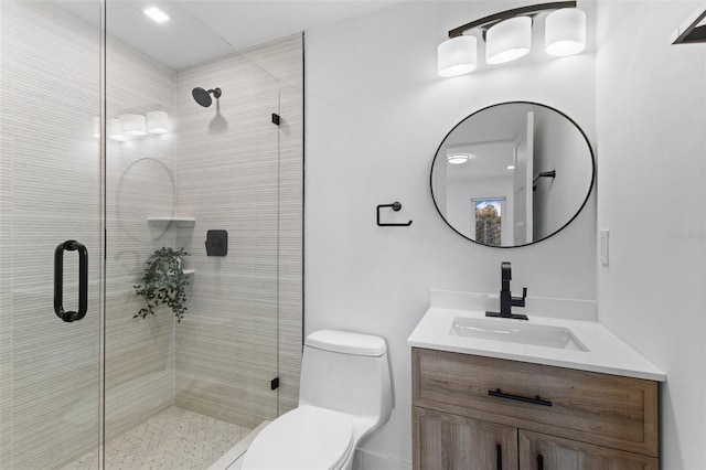 bathroom with walk in shower, vanity, and toilet