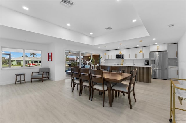 dining room featuring a wealth of natural light and light wood-type flooring