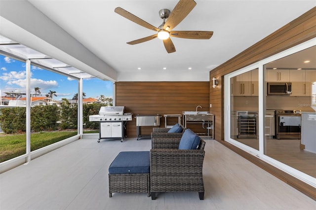 view of patio / terrace featuring ceiling fan, a grill, and beverage cooler