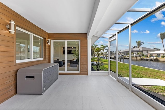 sunroom / solarium with a water view