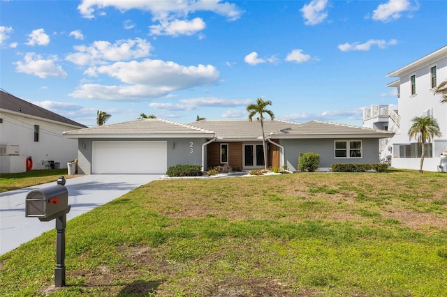 ranch-style house with a garage and a front lawn