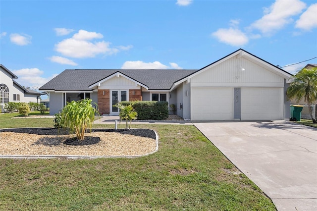 view of front of property with a garage and a front lawn