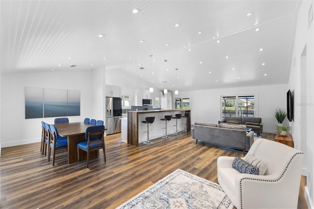 living room with hardwood / wood-style flooring and high vaulted ceiling