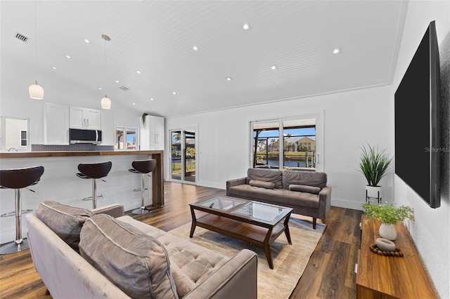 living room with hardwood / wood-style floors and high vaulted ceiling