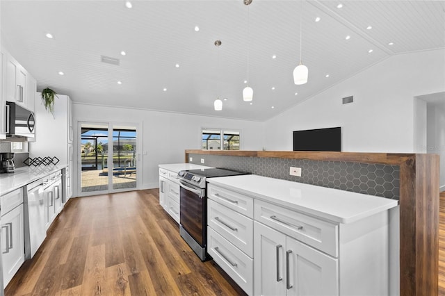 kitchen featuring dark wood-type flooring, lofted ceiling, white cabinetry, pendant lighting, and stainless steel appliances