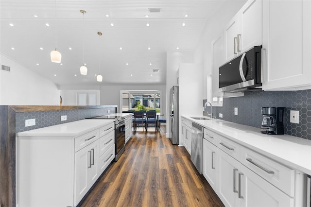 kitchen with white cabinetry, hanging light fixtures, stainless steel appliances, and sink